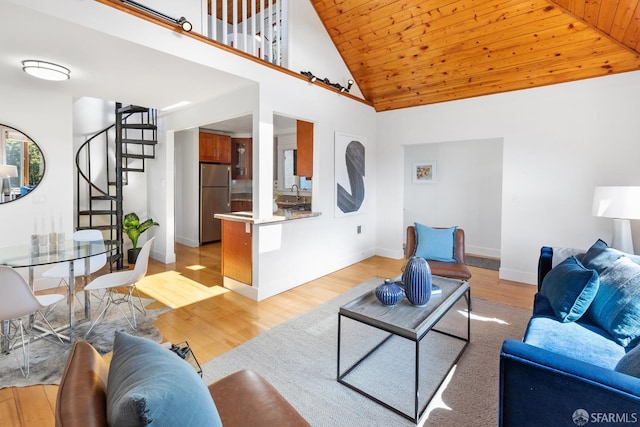 living room with stairway, wood ceiling, light wood-type flooring, and high vaulted ceiling