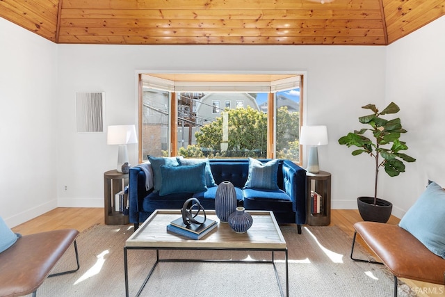 living area with baseboards and wood finished floors