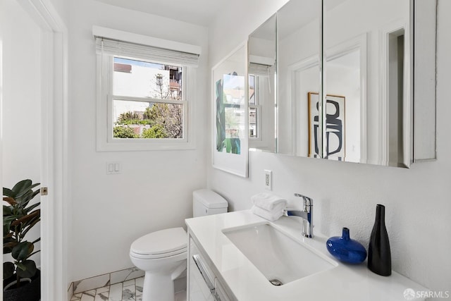 bathroom featuring vanity and toilet