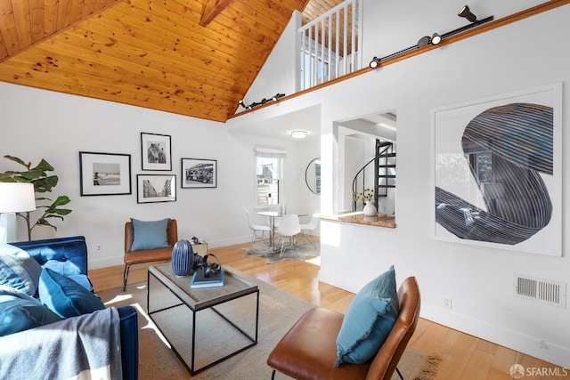 living room featuring visible vents, baseboards, stairway, wooden ceiling, and wood finished floors