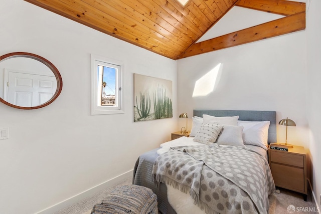 carpeted bedroom featuring baseboards, wood ceiling, and vaulted ceiling