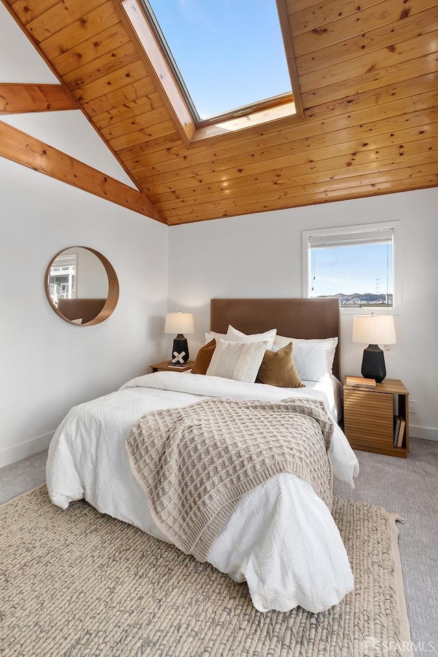 bedroom with a skylight, wood ceiling, baseboards, and carpet floors