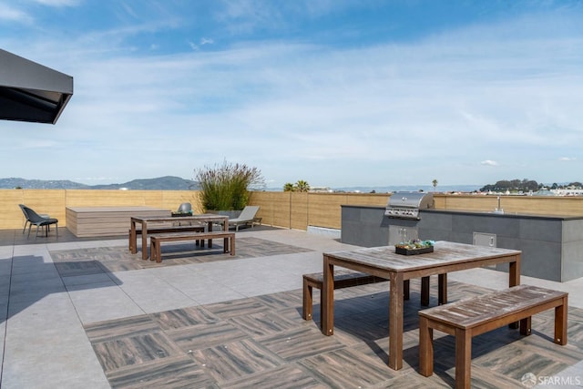 view of patio / terrace with grilling area and a mountain view