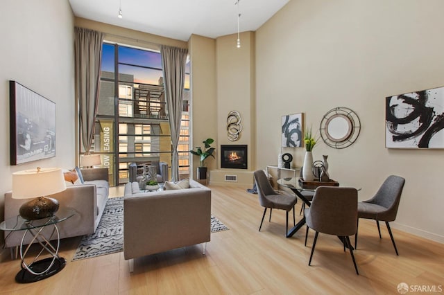 interior space featuring a large fireplace and light hardwood / wood-style floors