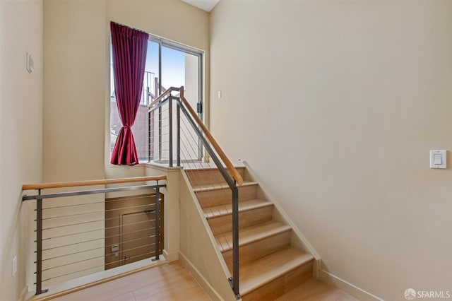 stairs featuring hardwood / wood-style floors