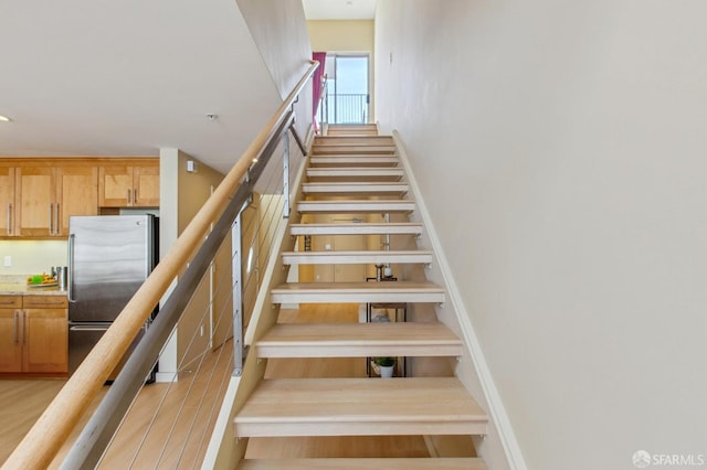 stairway with hardwood / wood-style flooring