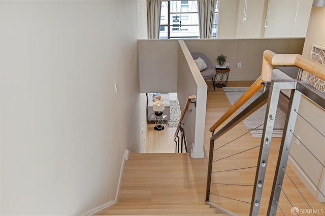 stairs with hardwood / wood-style flooring