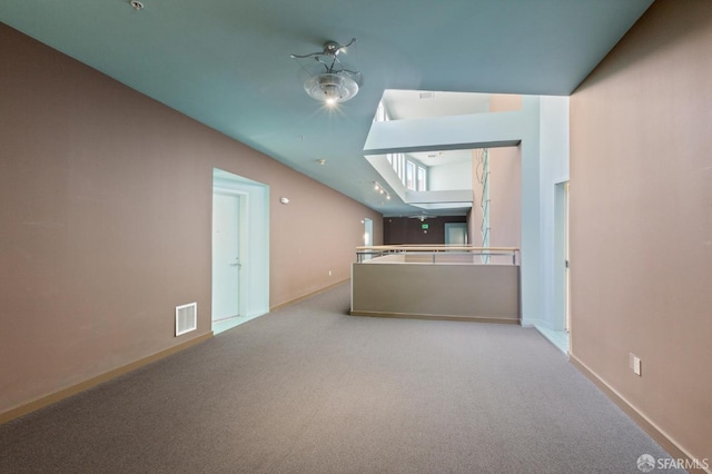 unfurnished living room featuring light carpet