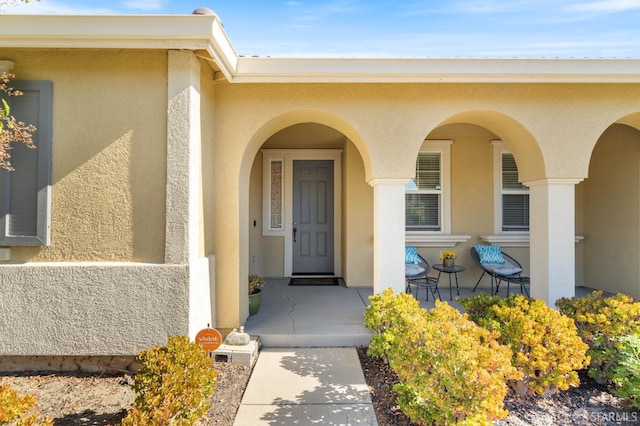 doorway to property featuring covered porch