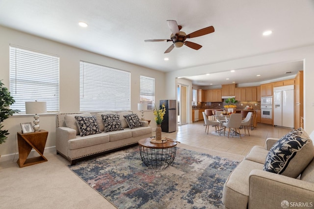 tiled living room with ceiling fan