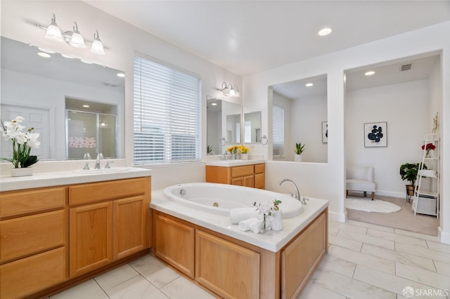 bathroom featuring vanity and separate shower and tub