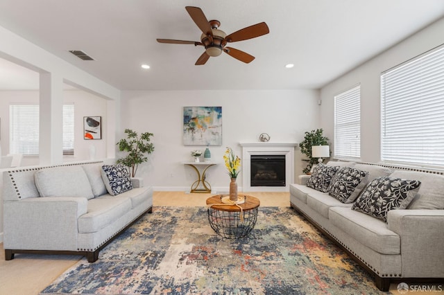 carpeted living room featuring ceiling fan