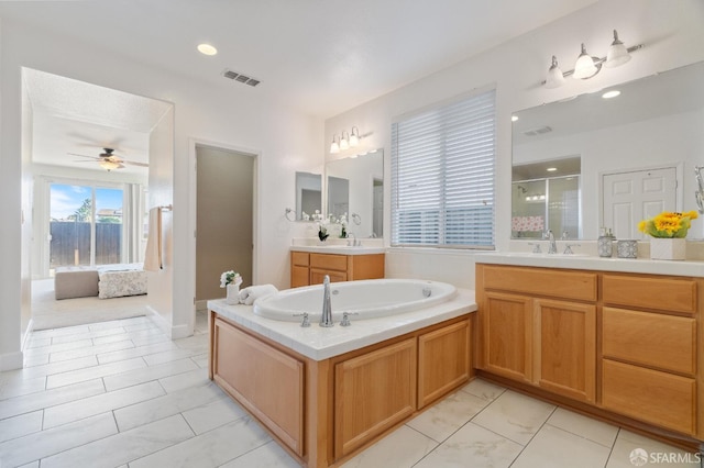 bathroom with vanity, ceiling fan, tile patterned floors, and plus walk in shower