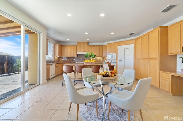 dining area with light tile patterned flooring