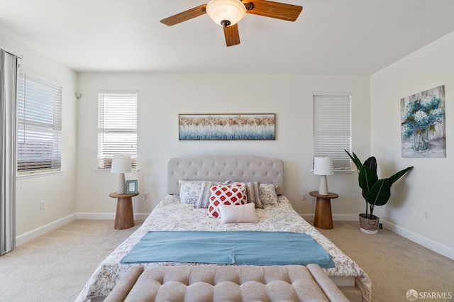 bedroom with ceiling fan and light colored carpet