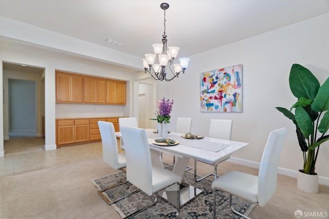 carpeted dining room with a notable chandelier