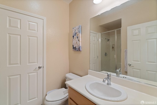 bathroom with vanity, toilet, and walk in shower