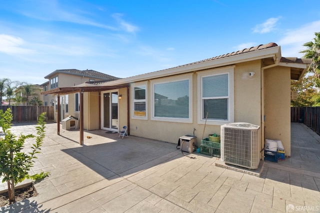 back of property featuring central AC unit and a patio