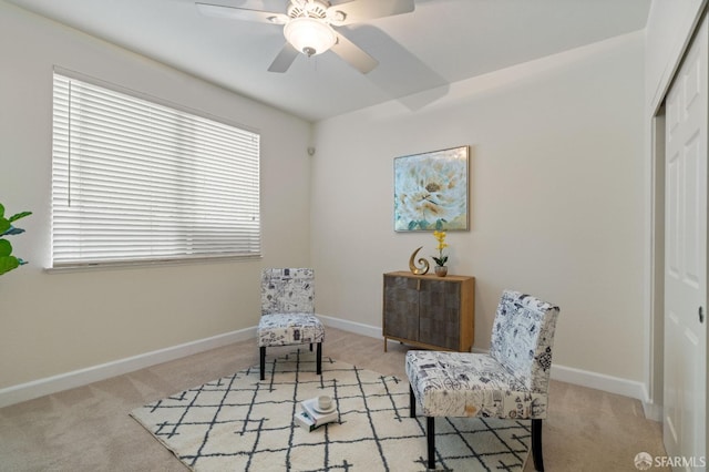 sitting room featuring ceiling fan and light carpet