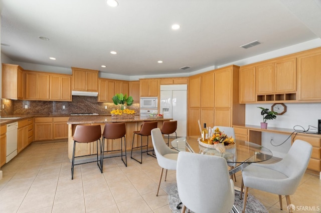 dining space with sink and light tile patterned floors