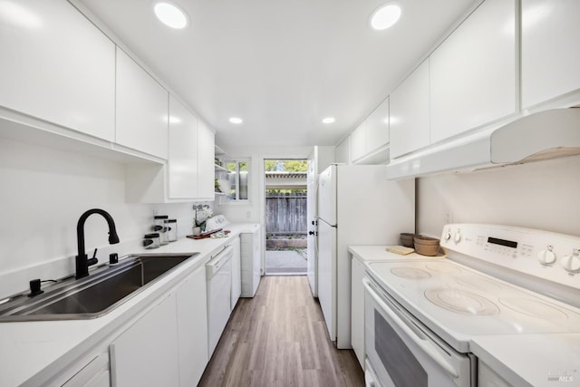 700 Samoa Ln, Novato, CA 94947 - kitchen featuring white appliances, a sink, white cabinetry, washer / clothes dryer, and light countertops