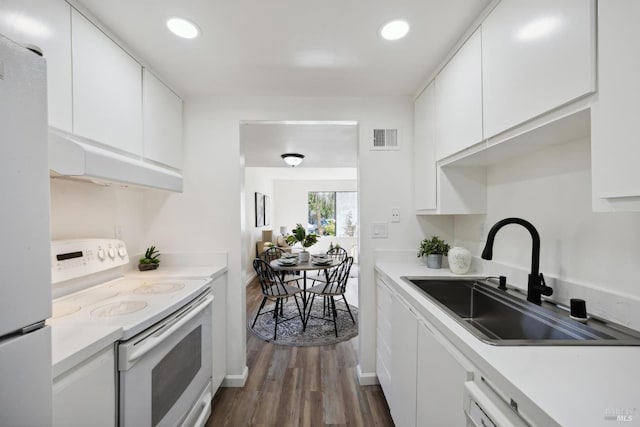 700 Samoa Ln, Novato, CA 94947 - kitchen featuring white appliances, a sink, white cabinetry, dark wood-style flooring, and light countertops