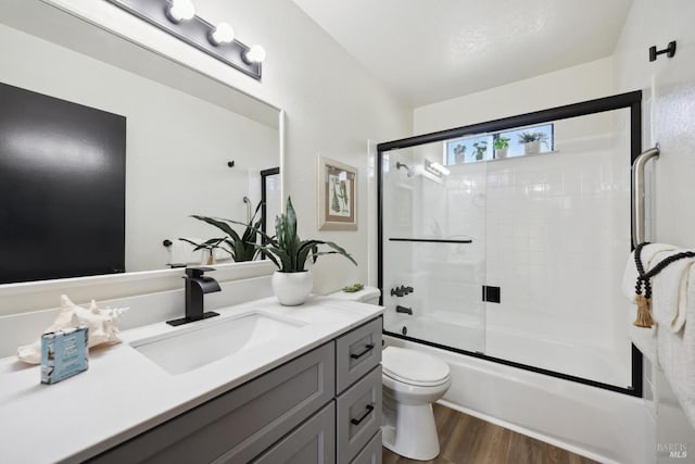 700 Samoa Ln, Novato, CA 94947 - full bath with vanity, toilet, wood finished floors, and bath / shower combo with glass door