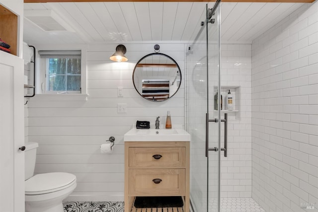 full bath featuring toilet, a stall shower, and vanity