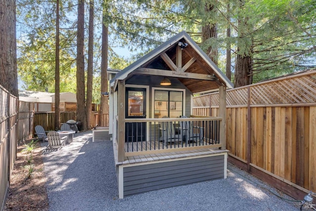 rear view of property featuring an outbuilding and a fenced backyard