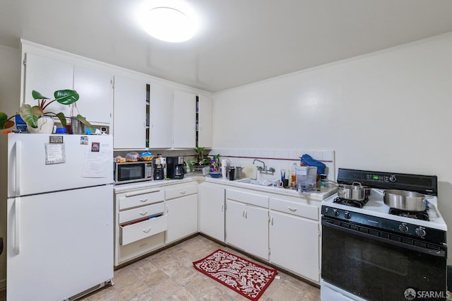 kitchen with white appliances and white cabinetry