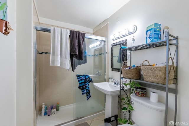 bathroom with walk in shower, toilet, and tile patterned floors