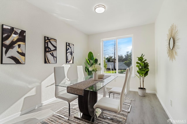 dining room with light wood-style flooring and baseboards