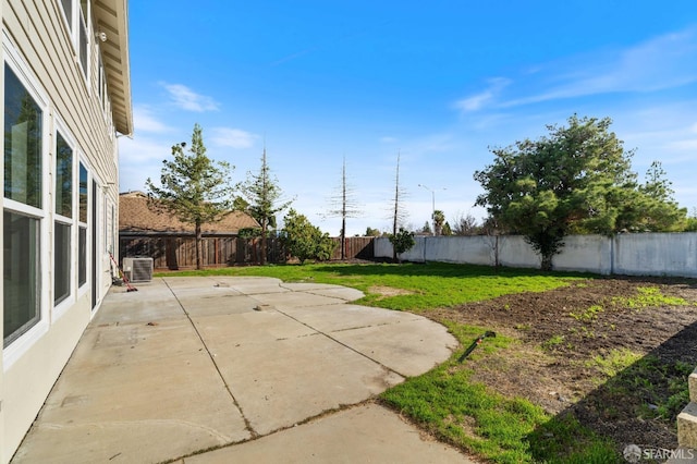 exterior space with central air condition unit, a fenced backyard, and a patio