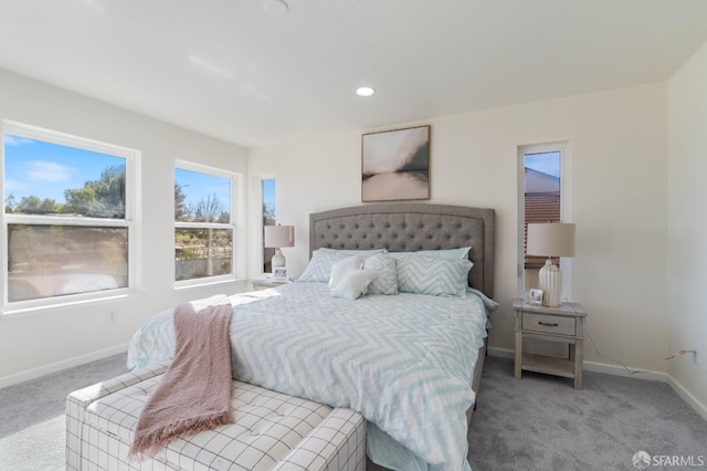 bedroom featuring light carpet, recessed lighting, and baseboards