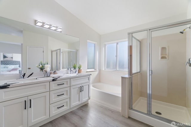 full bath featuring a sink, a shower stall, connected bathroom, and lofted ceiling