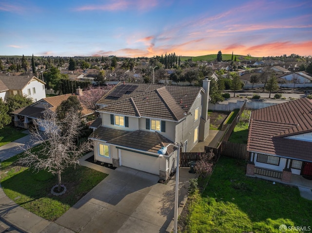 aerial view at dusk featuring a residential view