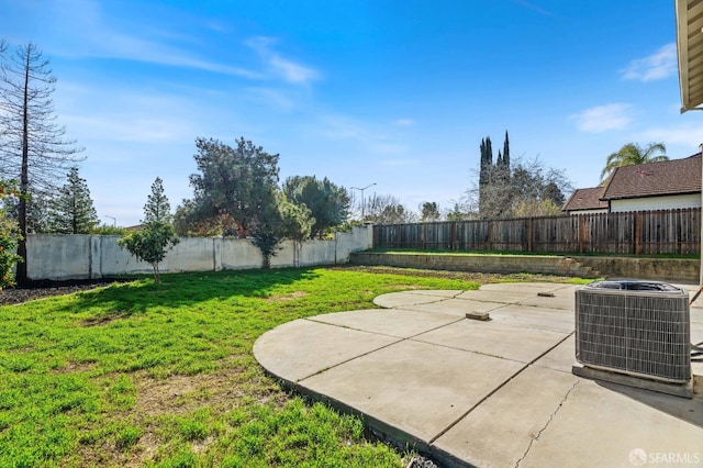 view of yard with a fenced backyard, a patio, and central air condition unit