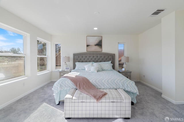 bedroom featuring baseboards, recessed lighting, visible vents, and light colored carpet