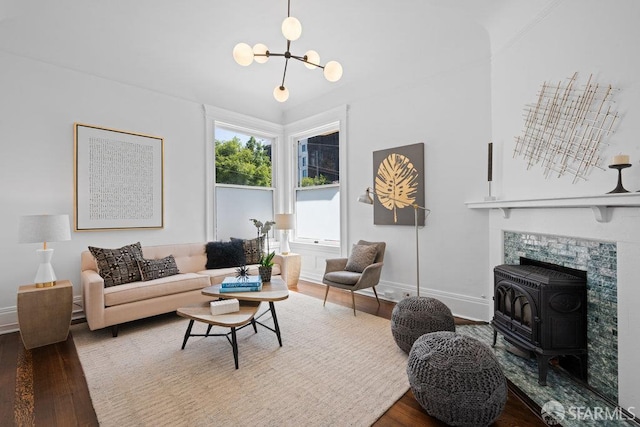 59 Octavia St, San Francisco, CA 94102 - living room featuring a wood stove, wood finished floors, a chandelier, and baseboards