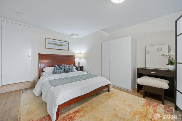 bedroom with a closet and wood finished floors