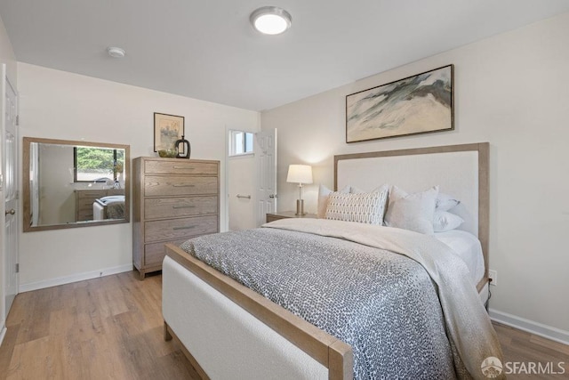 bedroom featuring baseboards and wood finished floors