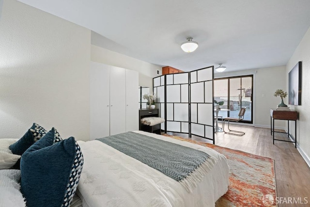 bedroom featuring baseboards and wood finished floors