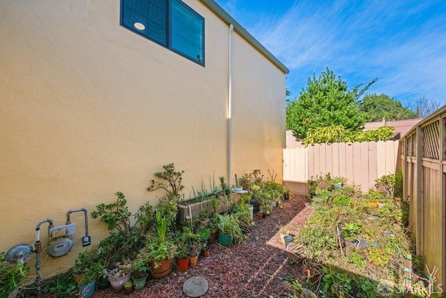 view of yard with fence and a vegetable garden