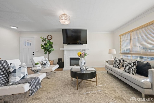 living room with a glass covered fireplace, crown molding, baseboards, and wood finished floors