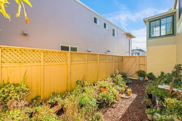 view of yard with a gate and a fenced backyard