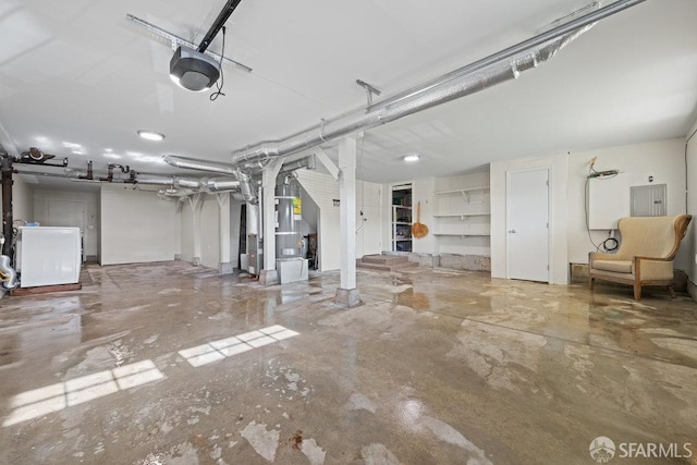 garage with washer / dryer, heating unit, electric panel, and a garage door opener