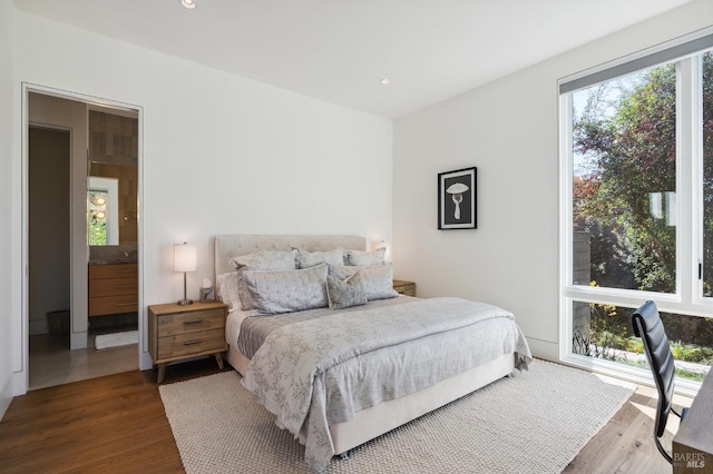 bedroom with wood finished floors and recessed lighting