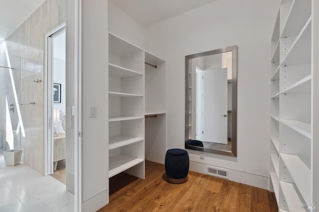 spacious closet featuring visible vents and light wood-style flooring