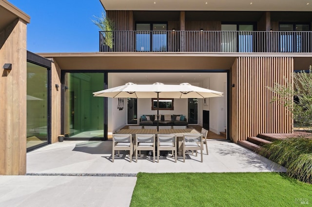 view of patio / terrace with outdoor dining area, outdoor lounge area, and a balcony