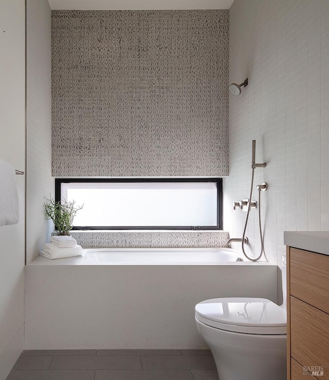 bathroom with a wealth of natural light, toilet, a bathing tub, tile patterned flooring, and tiled shower